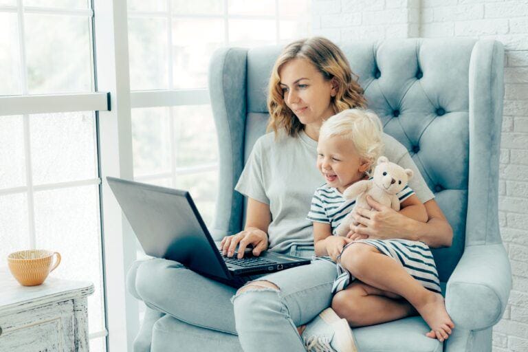 working mom working from home with laptop and baby