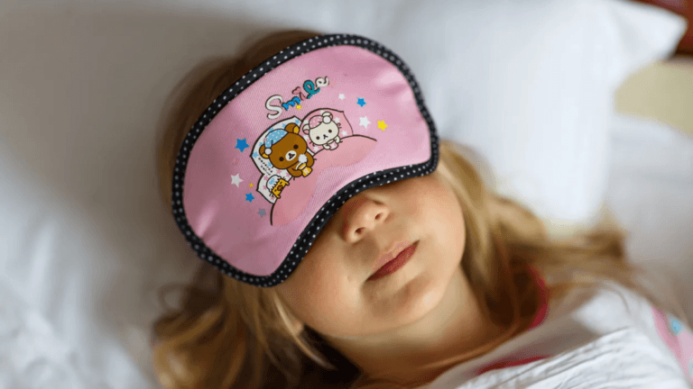 little girl sleeping with an eye mask