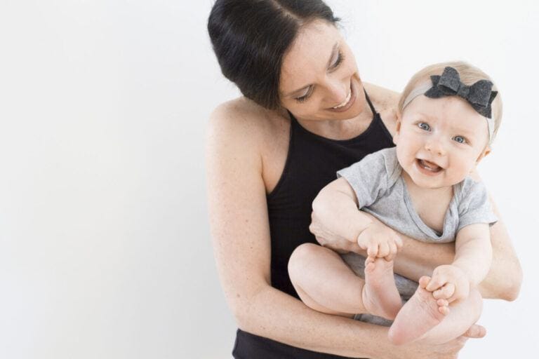 breastfeeding magic: mom holding smiling baby in arms