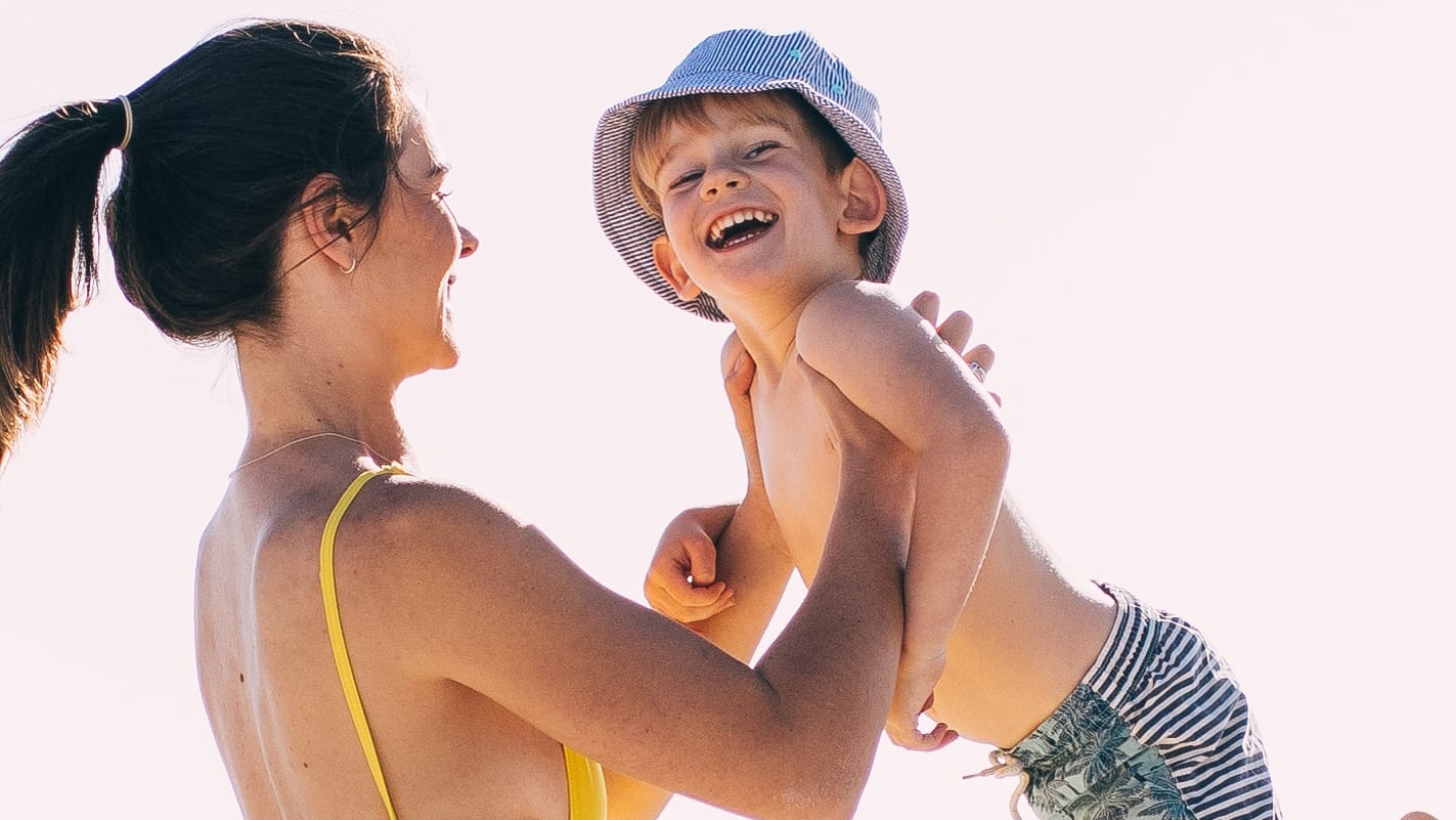 mom holding child in the air: our kids may not remember but we will