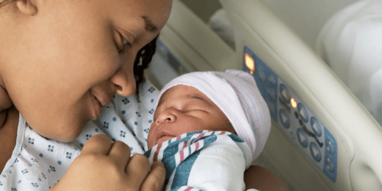 mom holding newborn baby in a hospital