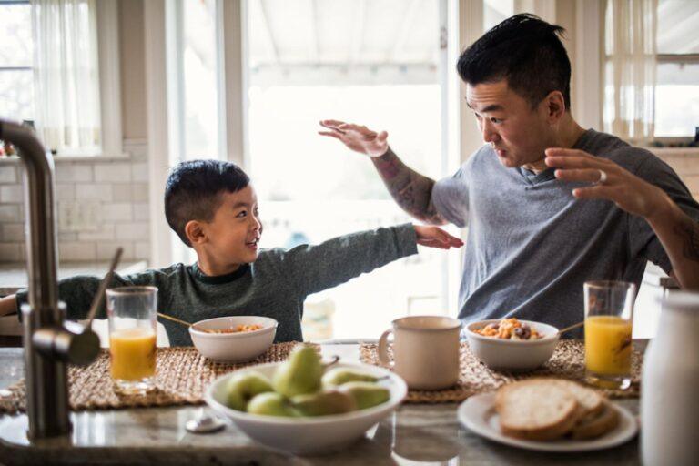 father and son eating breakfast