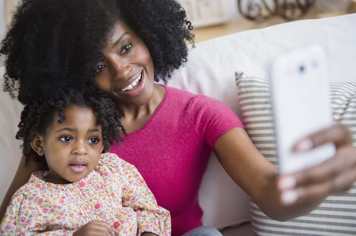 mom and her daughter holding a phone