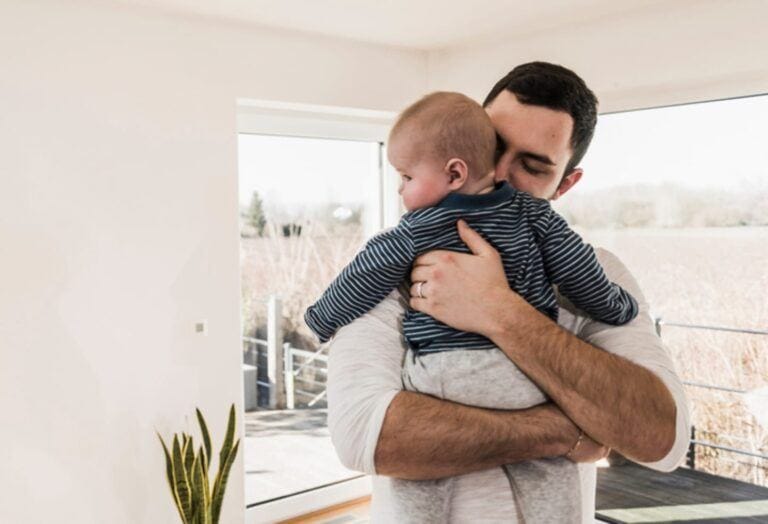 man carrying a baby