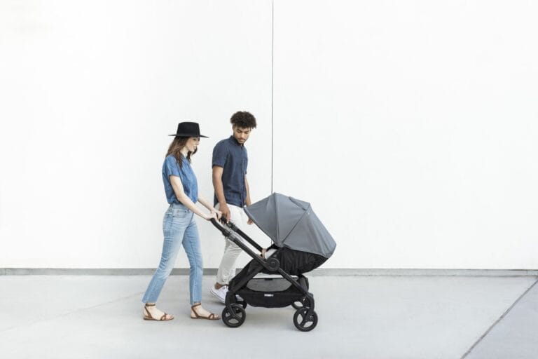 man and woman pushing a stroller