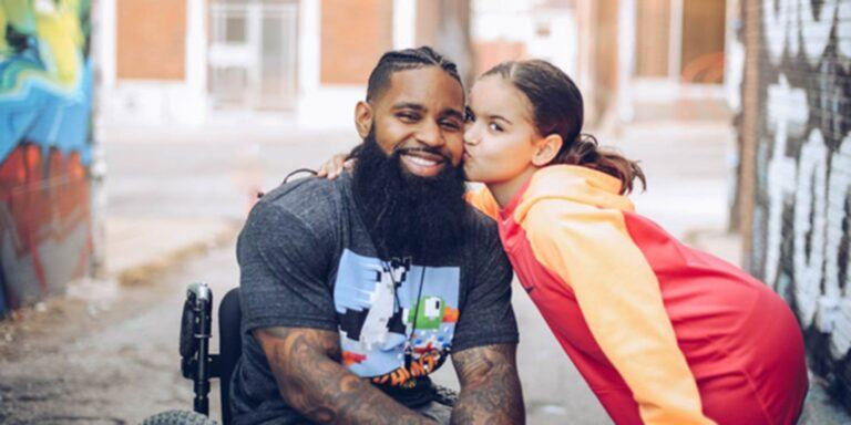 child kissing her father on the cheek