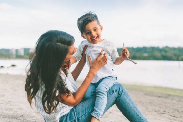 woman carrying and playing with toddler