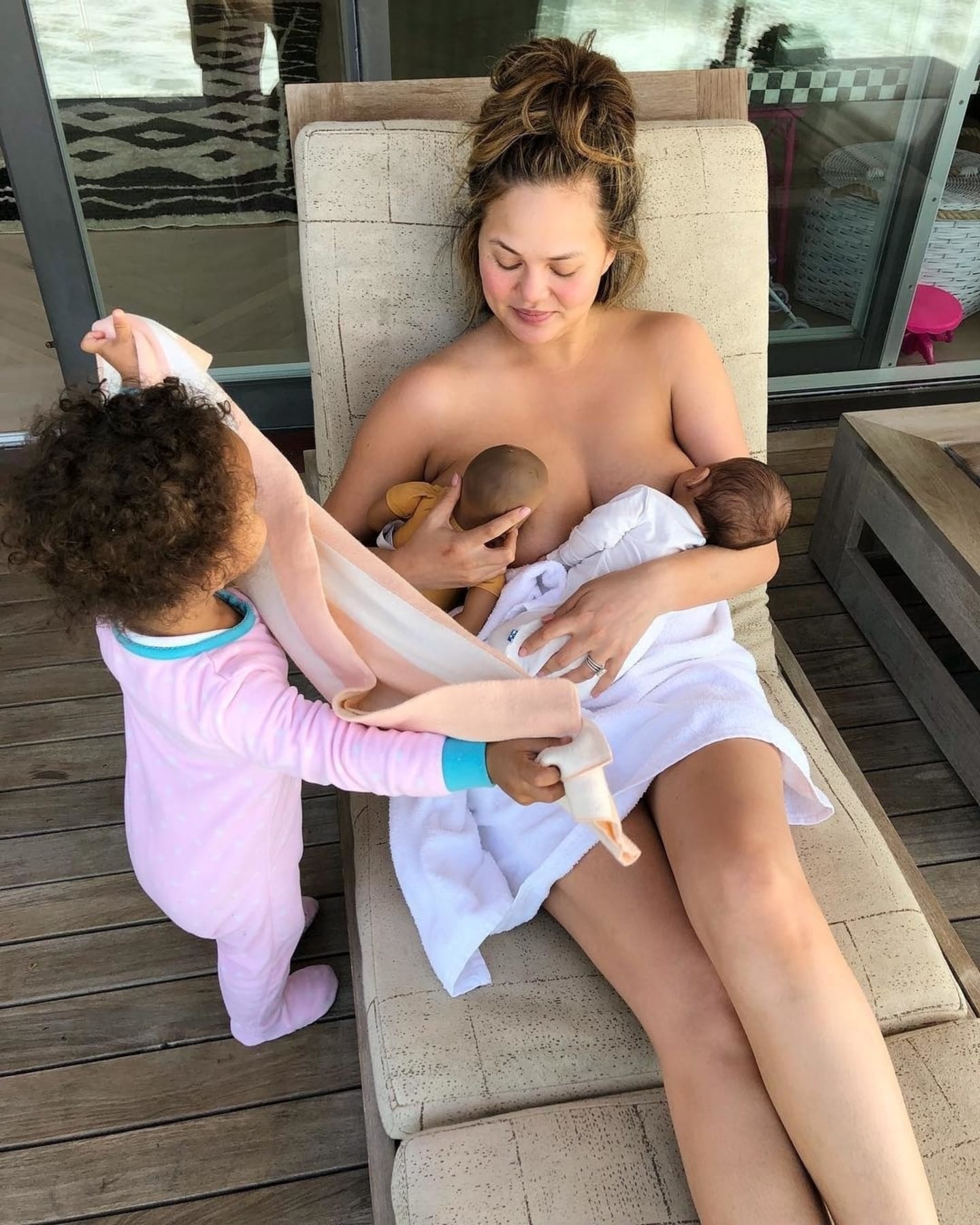 Chrissy Teigen breastfeeding child and doll