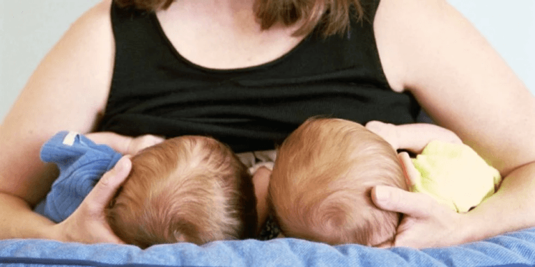 mom breastfeeding twins