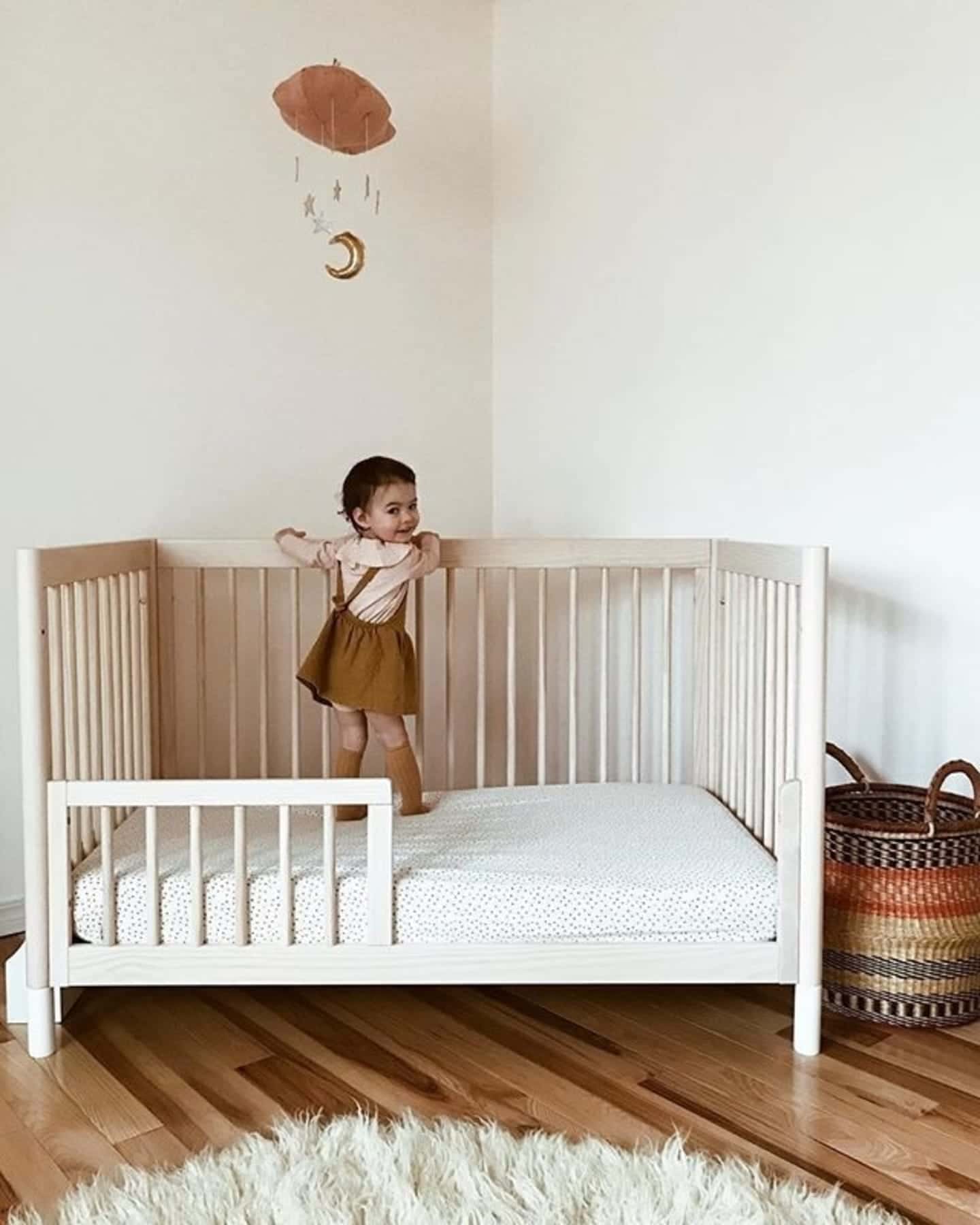 child standing inside a crib