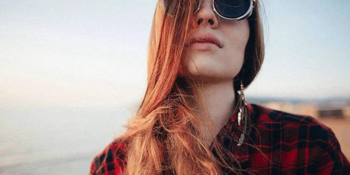 red haired woman with sunglasses outside