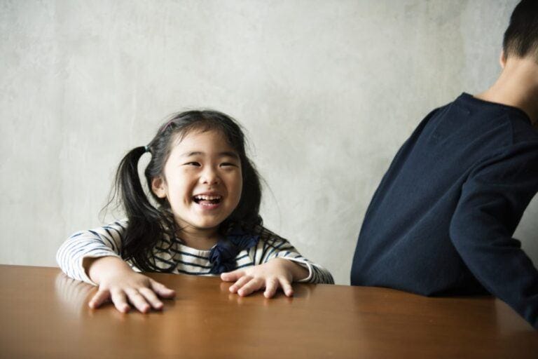 child in front of the table