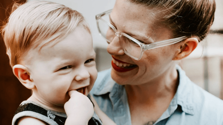 mom smiling at little boy