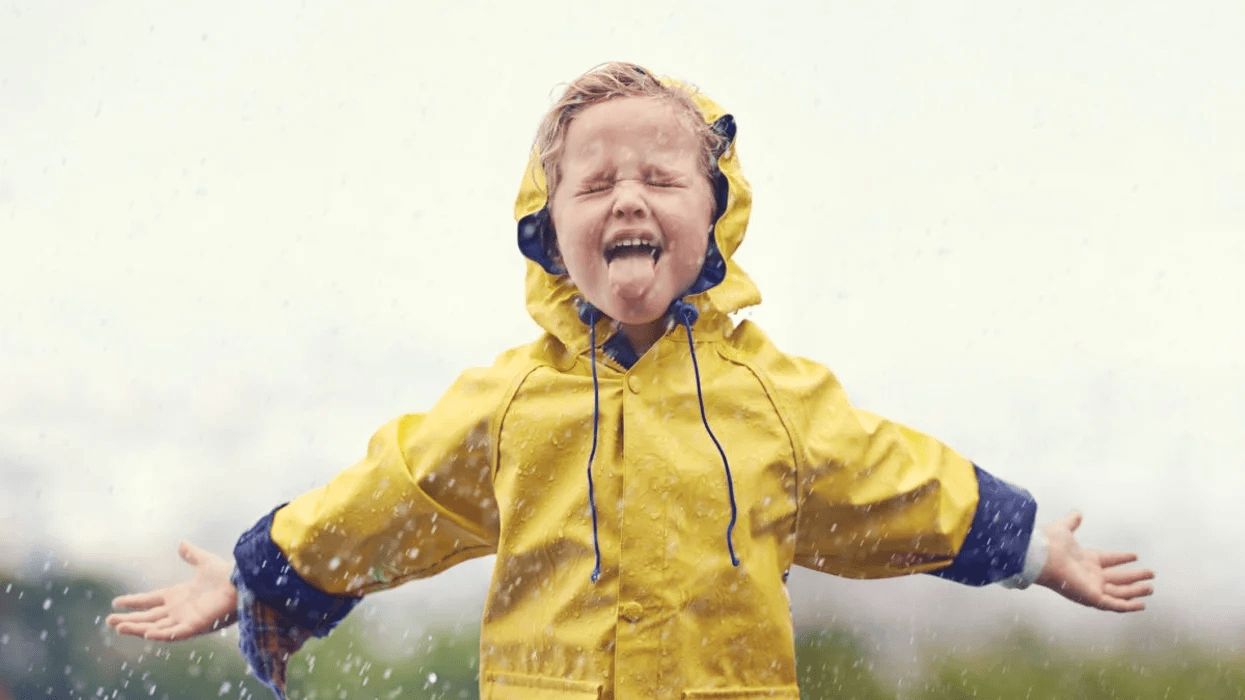 little-girl-standing-in-the-rain-with-her-tongue-out