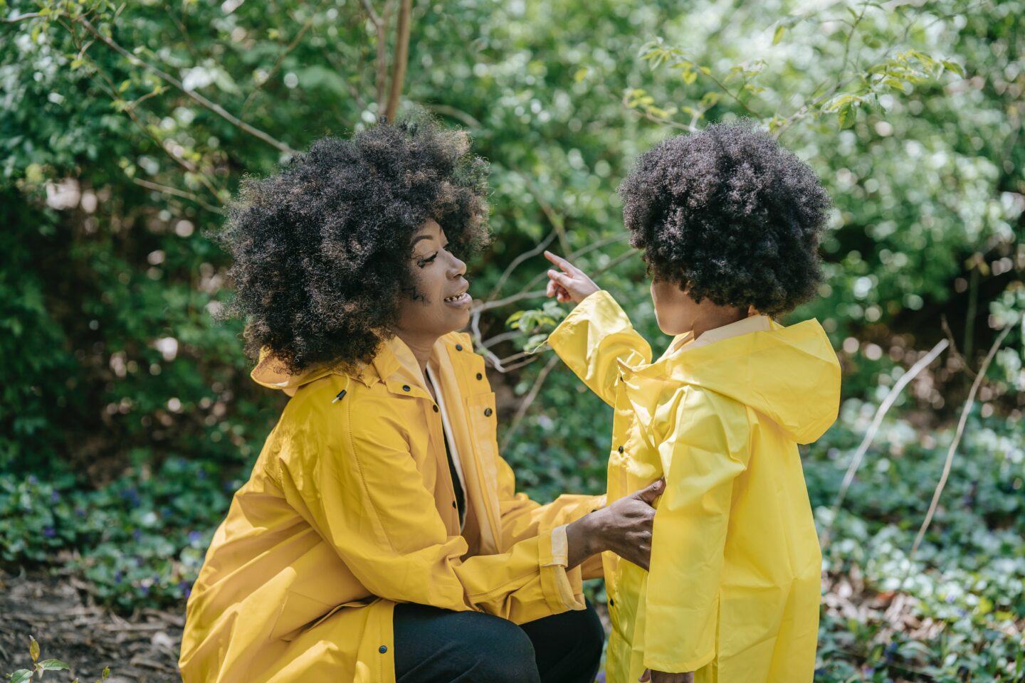 mom talking to child in yellow rain coat