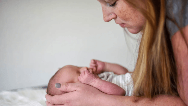 mom holding newborn baby's head