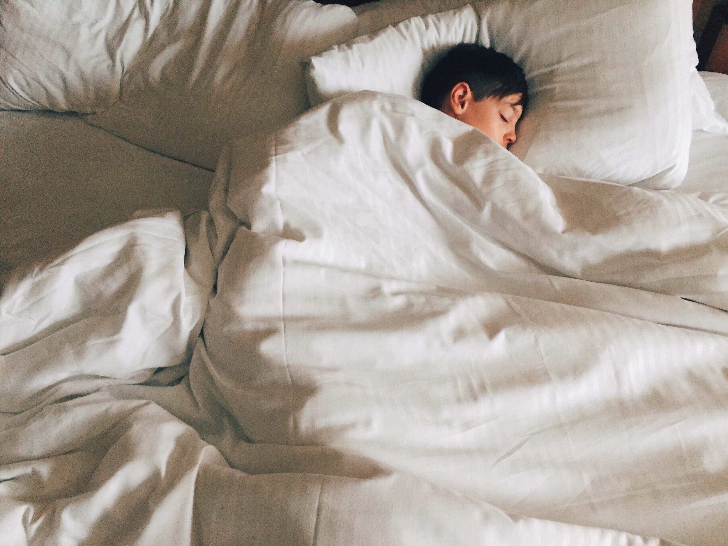 a child sleeping in a bed