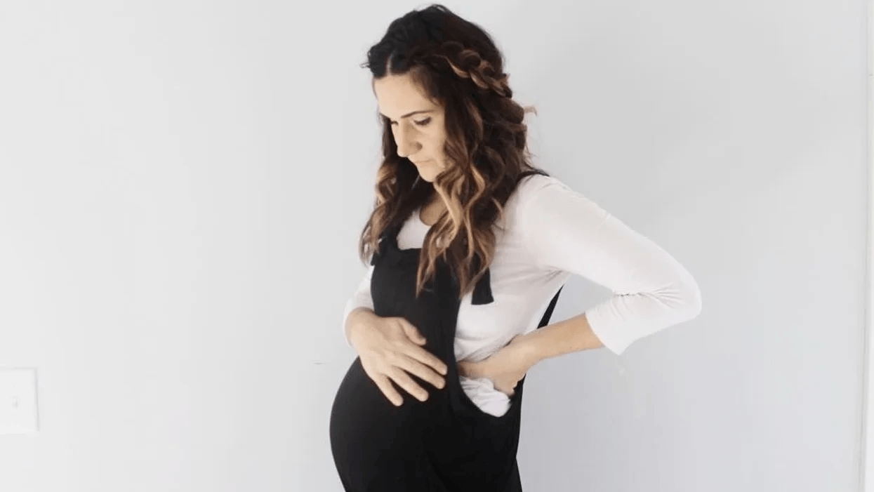 pregnant woman holding belly