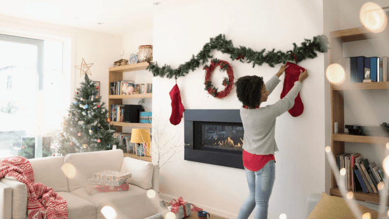 woman hanging up holiday decorations