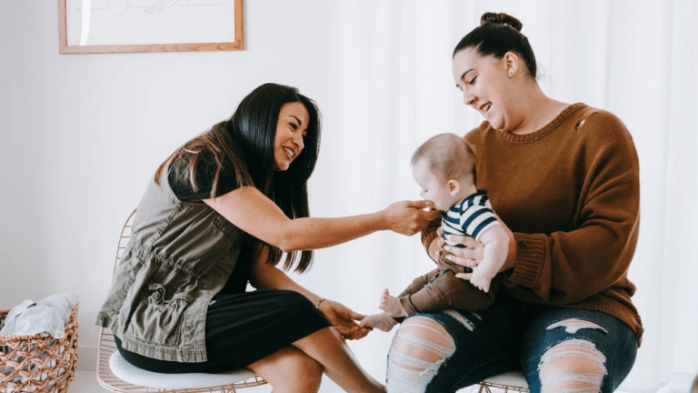 two moms playing with a toddler