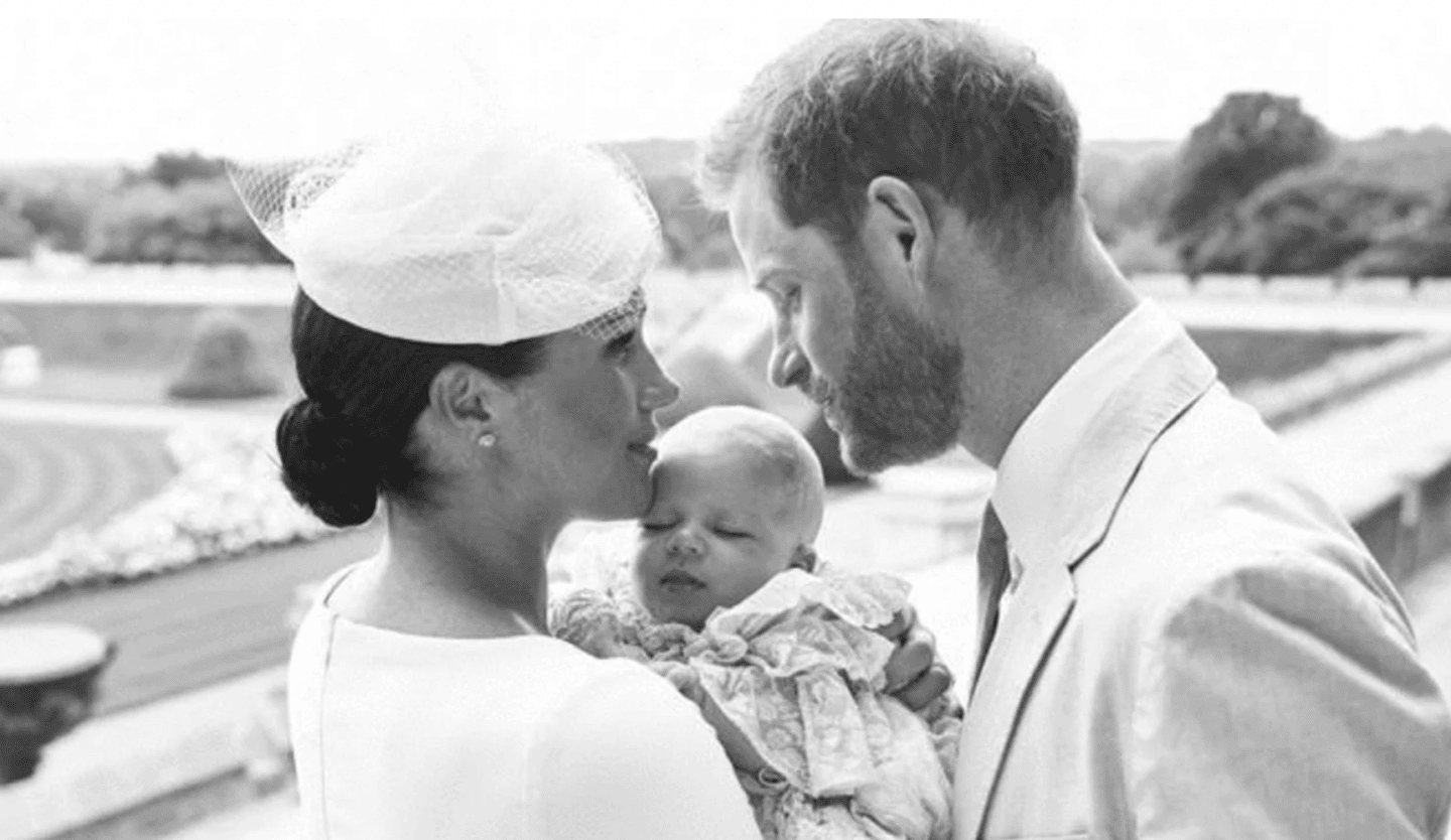 black and white photo of megan markle, baby archie and prince harry