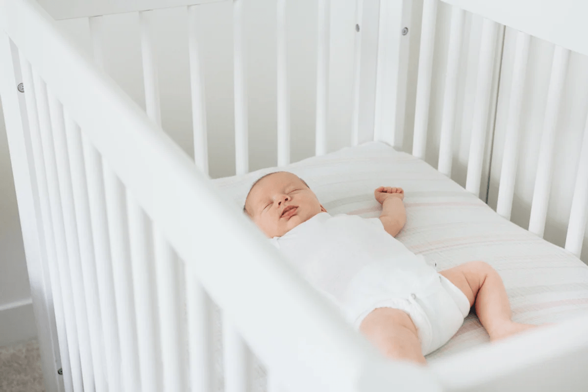 premie baby sleeping in a crib