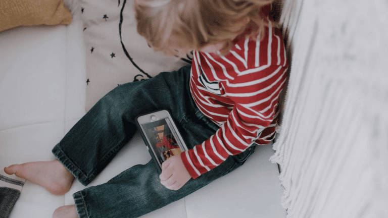 little boy watching something on a phone