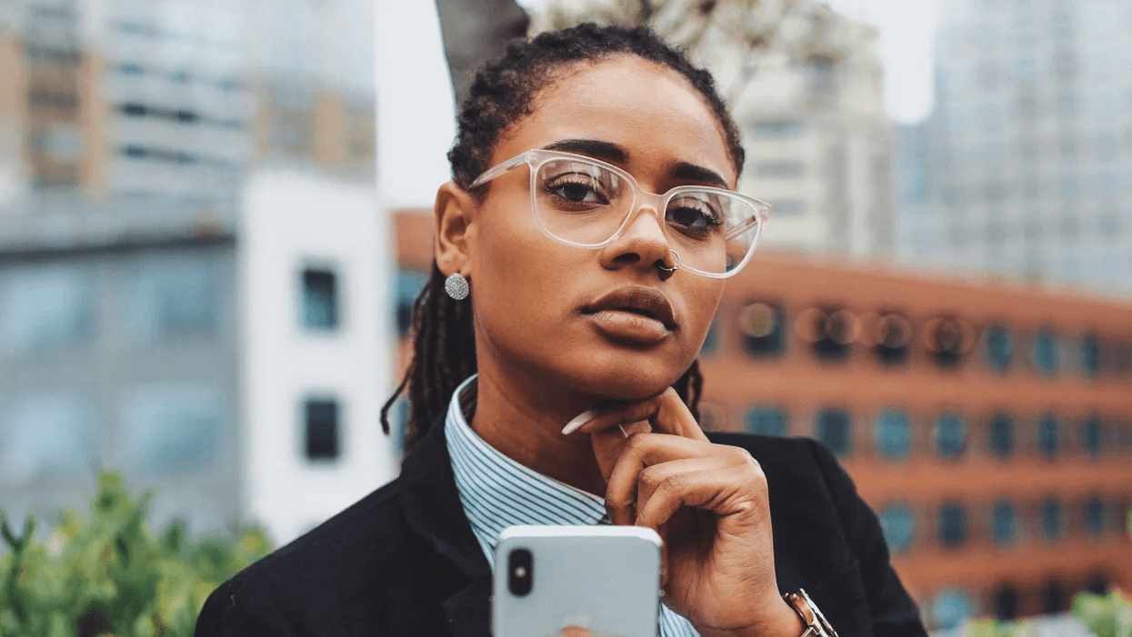 woman with a thoughtful look while on her phone