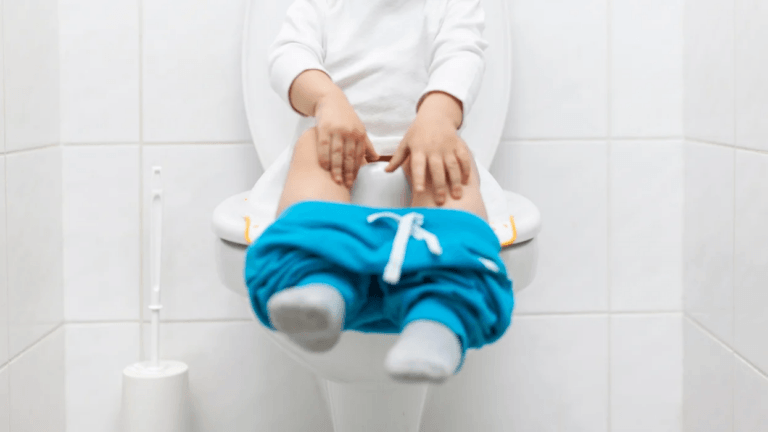 child sitting on the toilet