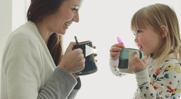 mom and daughter holding cups together