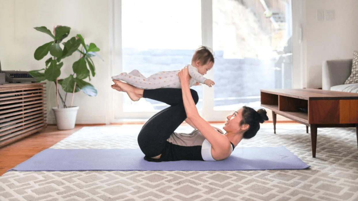 mom doing yoga with a baby