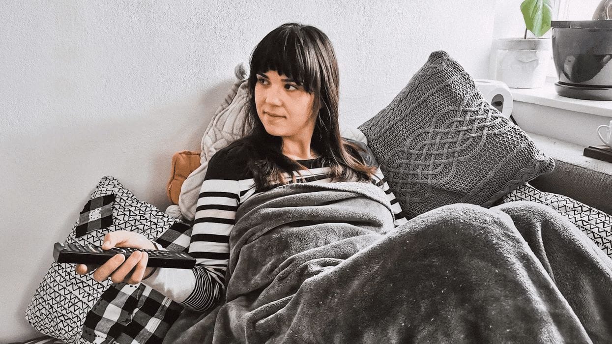 woman sitting on the couch with a remote