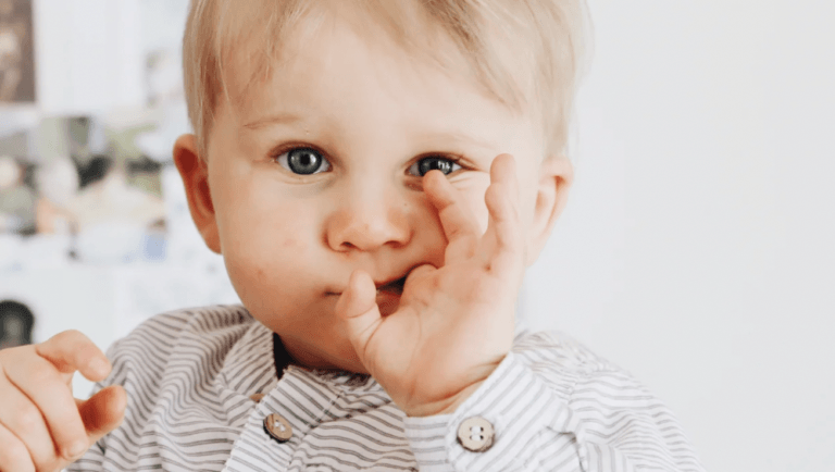 baby with fingers in his mouth