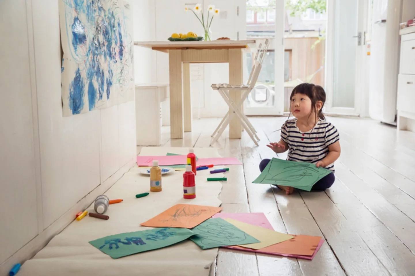 little girl drawing on the floor