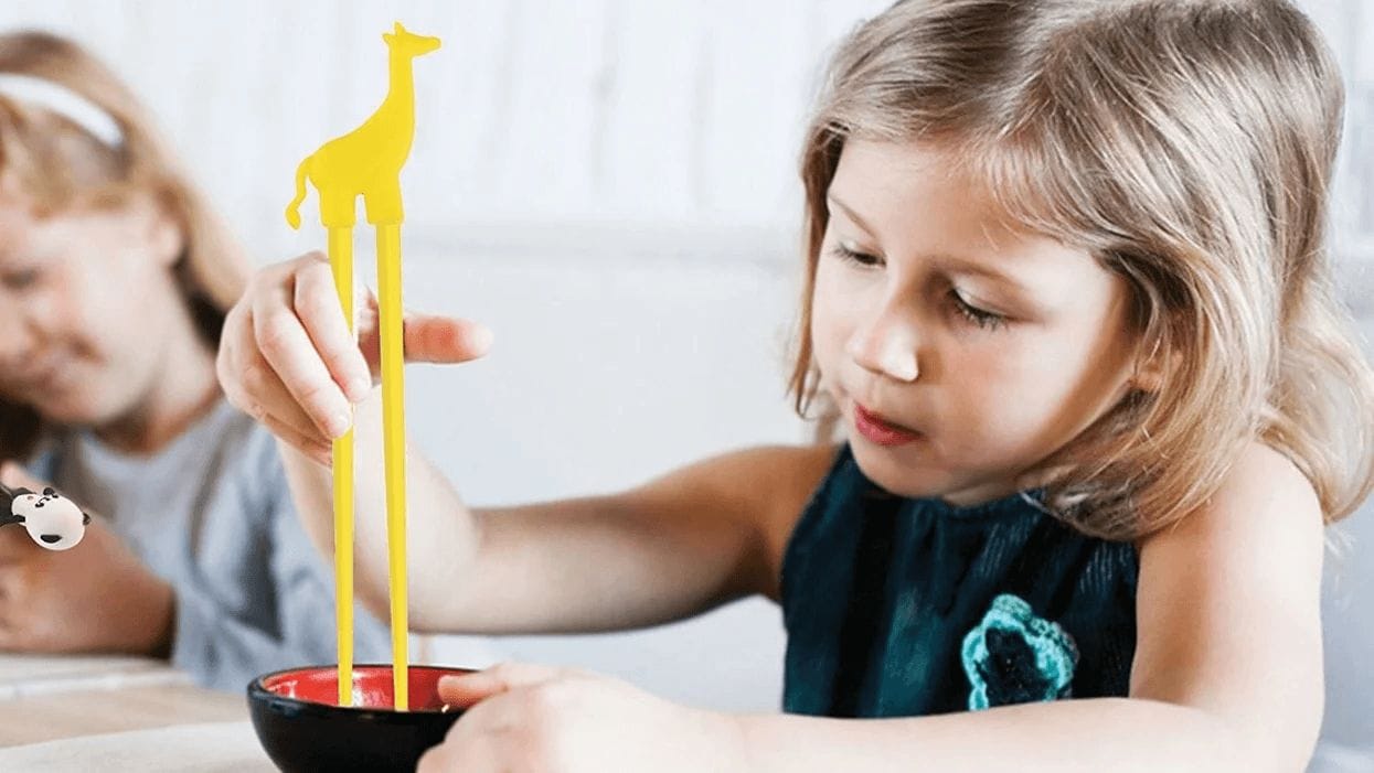 child eating with toddler tongs