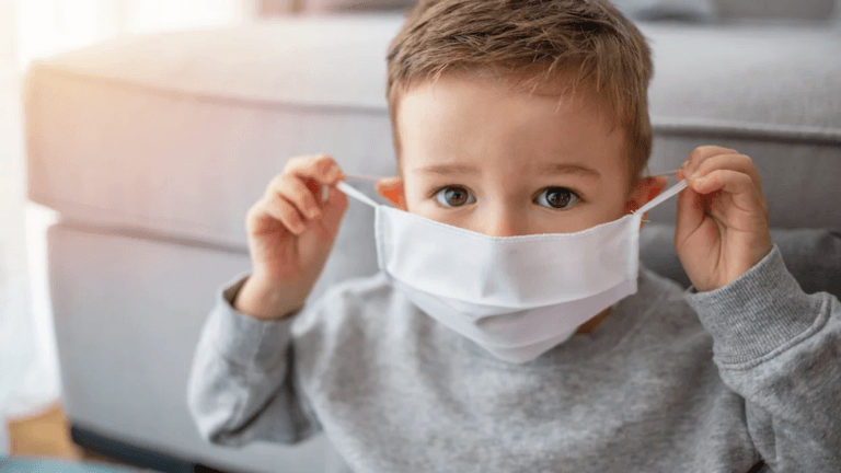 child putting on mask