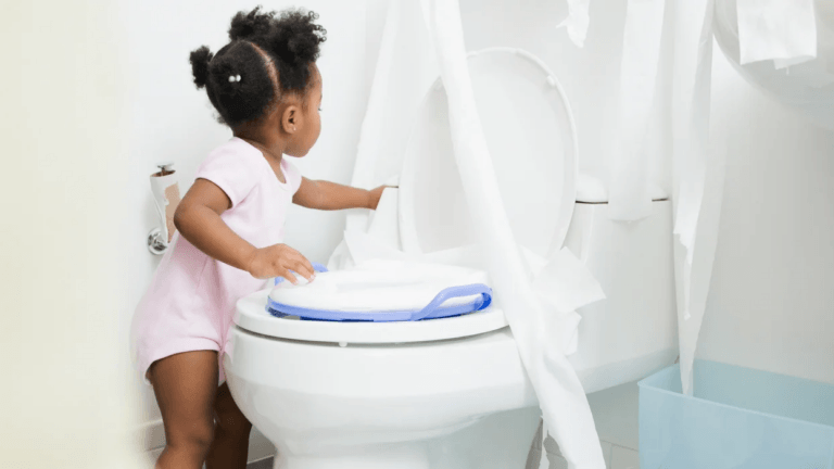 little girl playing with toilet paper