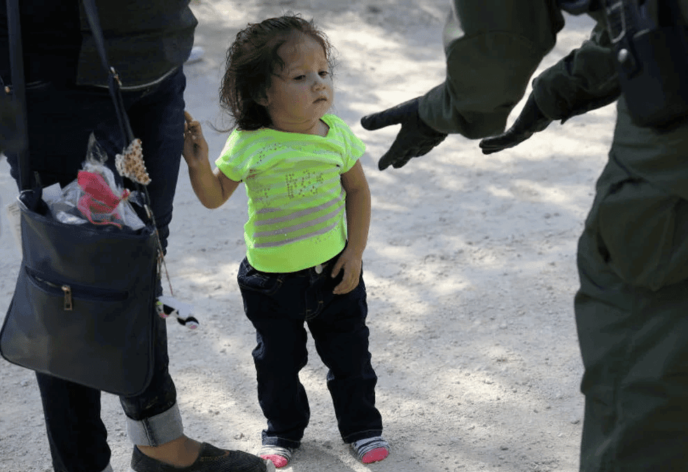 immigrant child with an officer