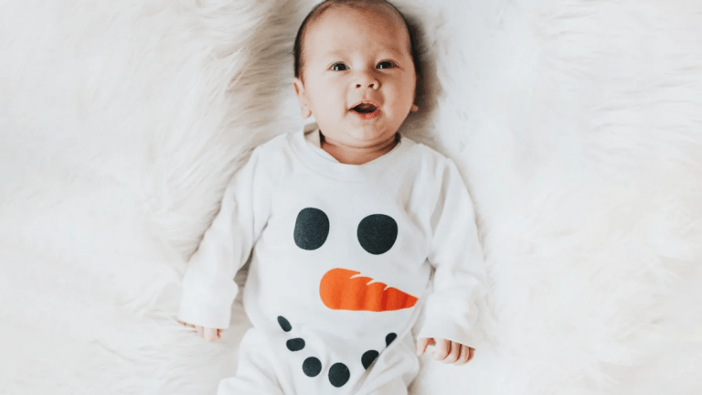 baby wearing a snowman outfit- december baby names