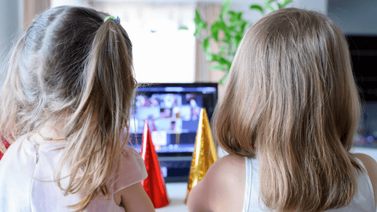 two sisters watching something on a tv