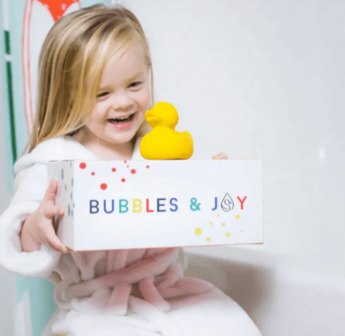 little girl with a bubbles and joy box