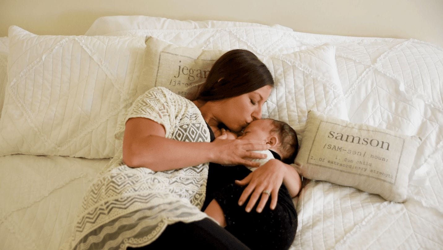 mom kissing baby on the forehead