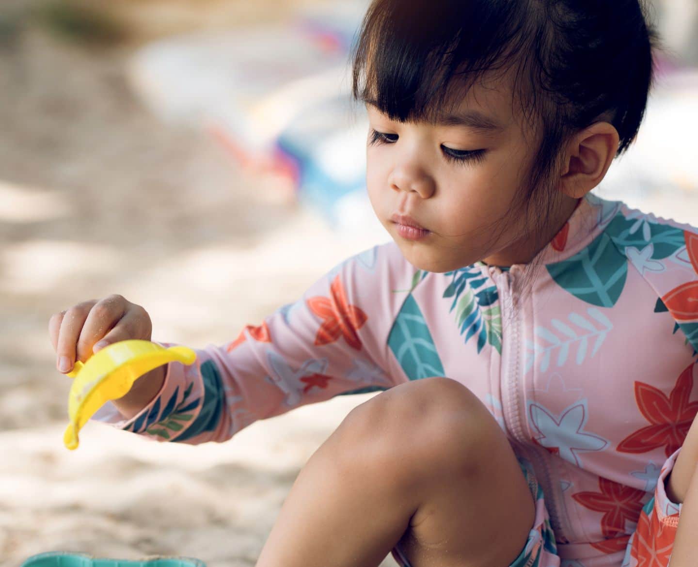 little girl playing on the beach