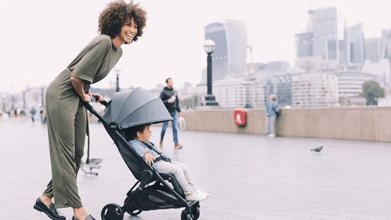 mom pushing baby in a stroller in the city