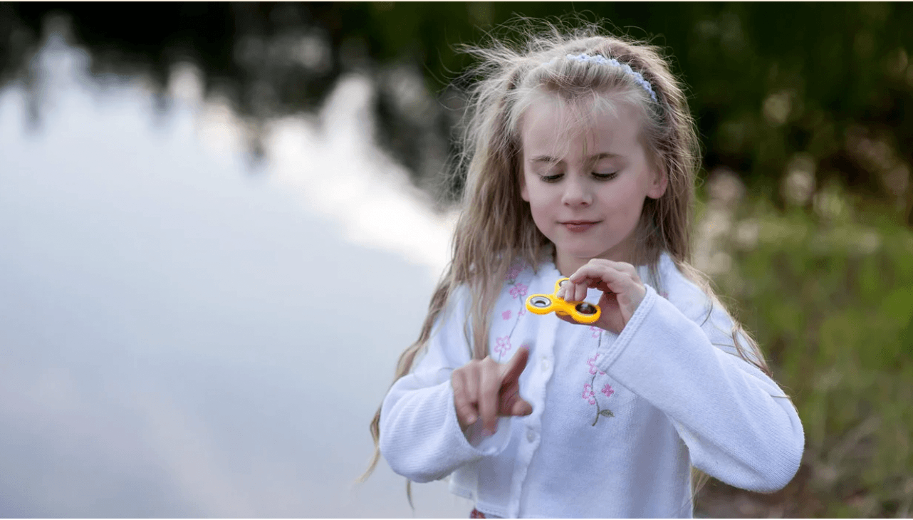 little girl playing with a fidget toys