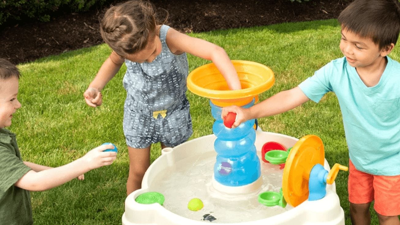 kids playing with a water table