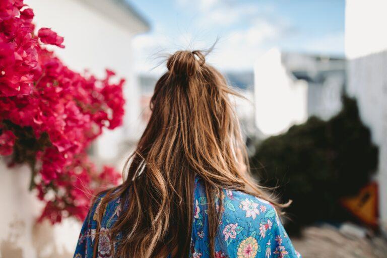 postpartum hair loss: woman with long hair photographed from behind