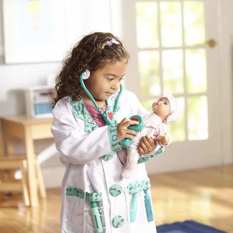 little girl playing with the Melissa & Doug doctor kit