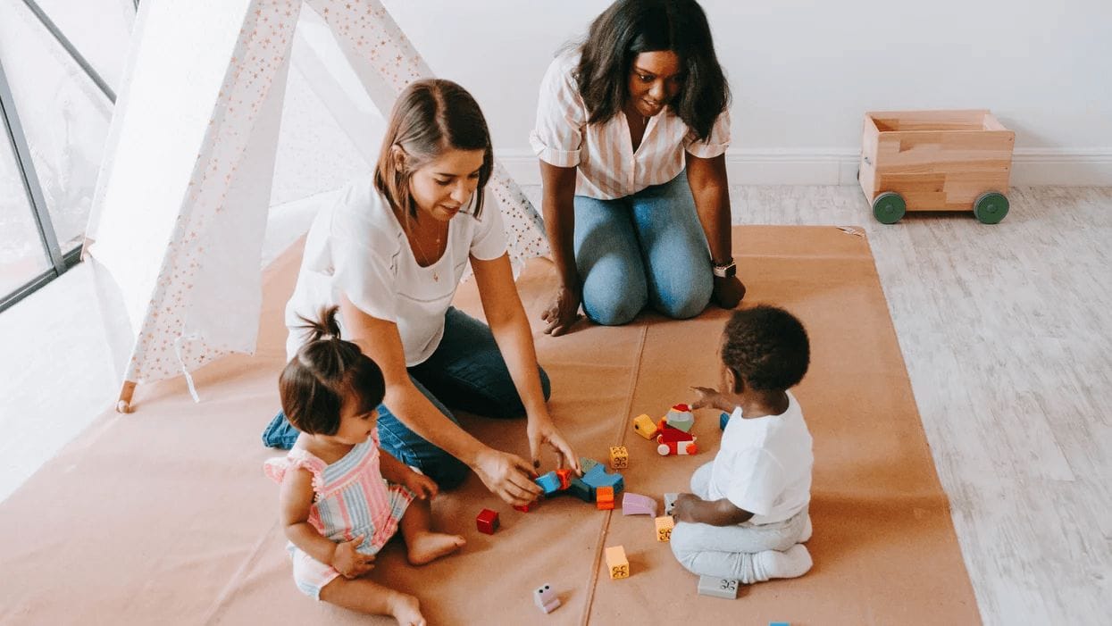 moms playing with kids on the floor