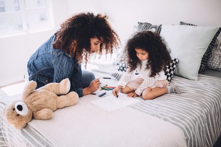 mom and child drawing on the bed- mom burnout